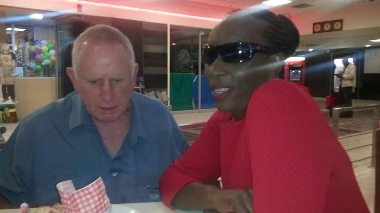 John shows Nosisa Apple's iPhone that caters for the blind